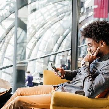 Young man in chair on smartphone