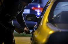 Car Thief Using a Screwdriver to Brake into a Car