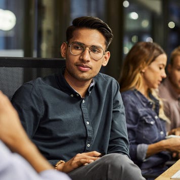 Office employees meet in a large room