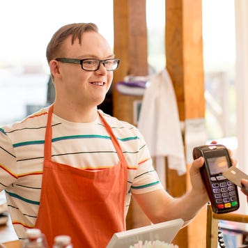 woman making a credit card purchase at cafe