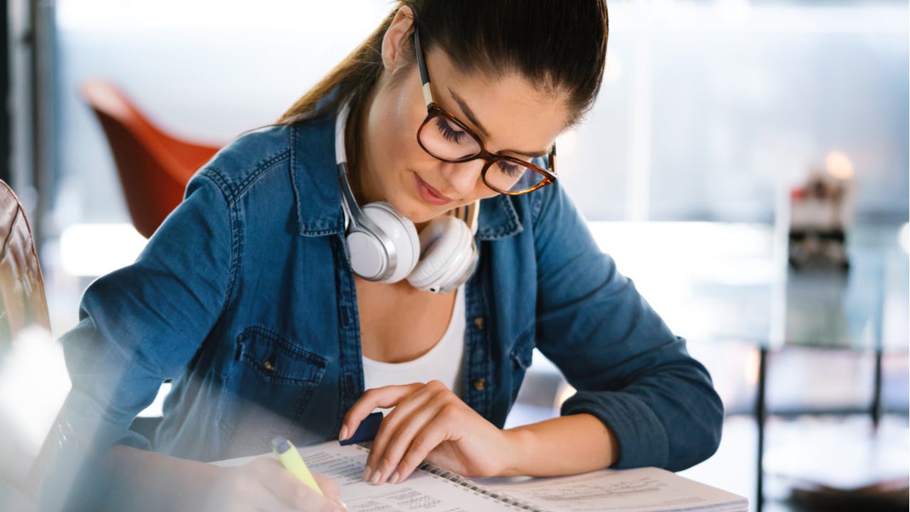 Woman studies with headphones