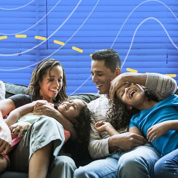 Two parents and two children sitting on a couch