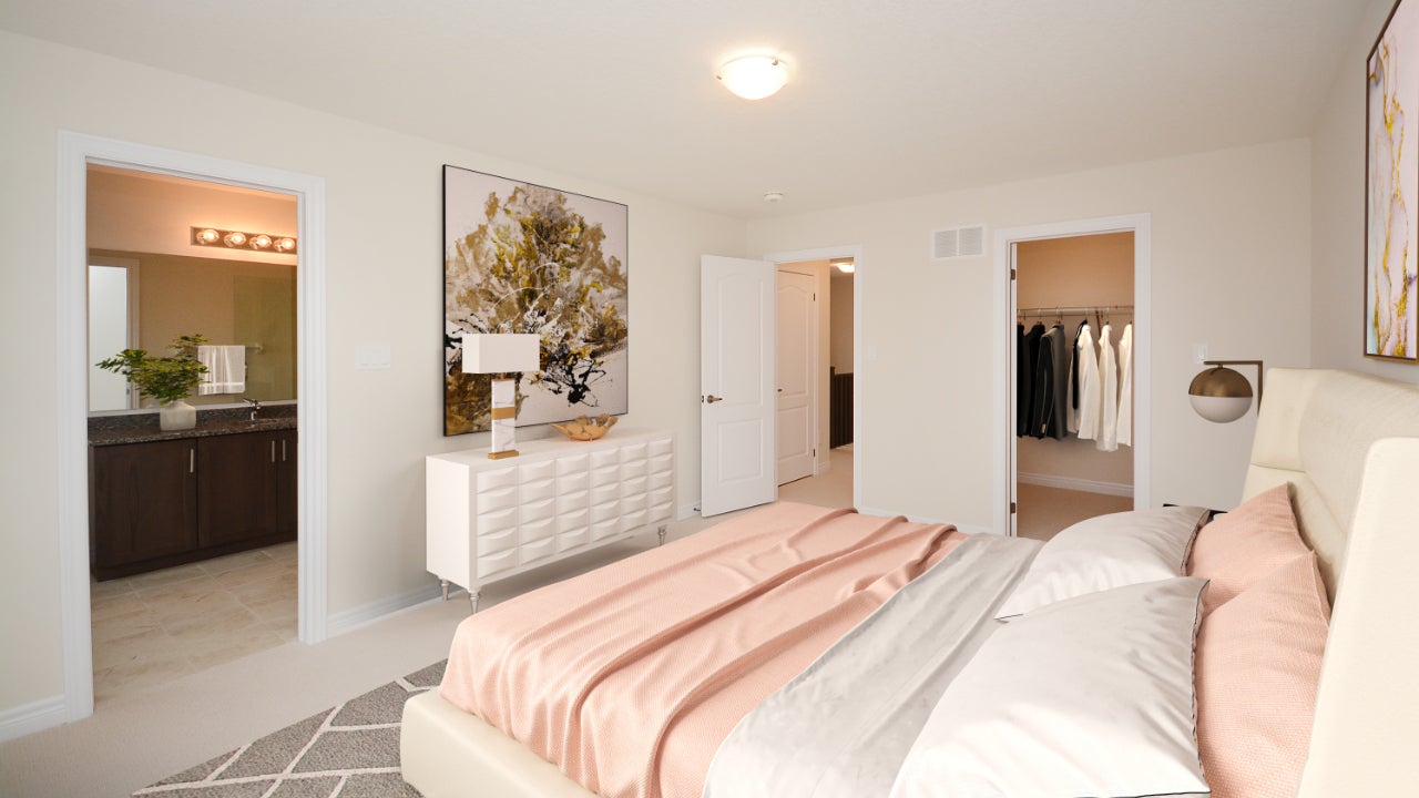 A digitally-staged bedroom with light pink bedspread 