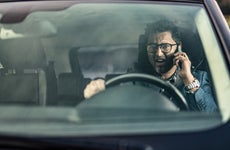Frustrated Man Driving And Talking On Phone.