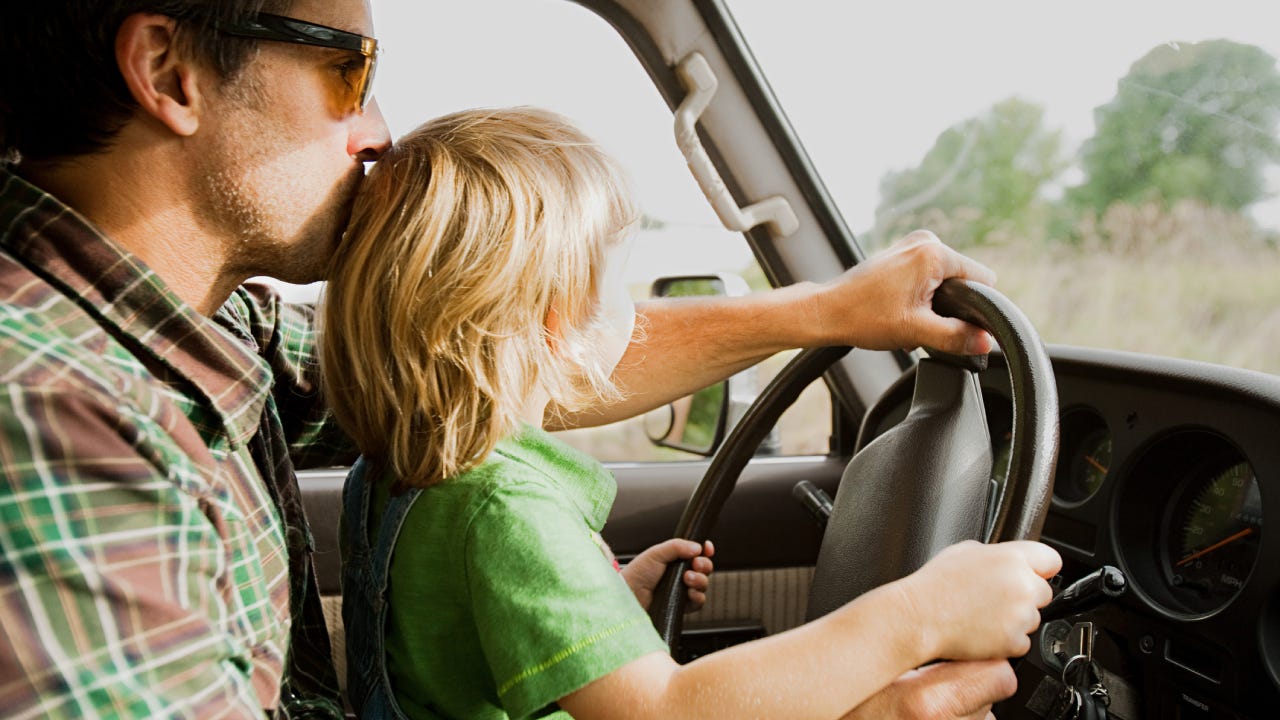 Father and son at wheel of a car