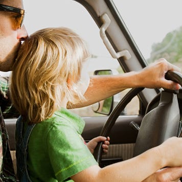 Father and son at wheel of a car