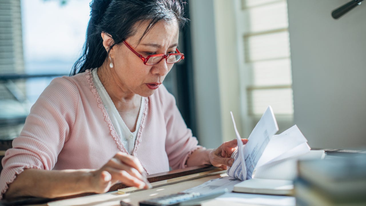 Senior woman doing finances at home