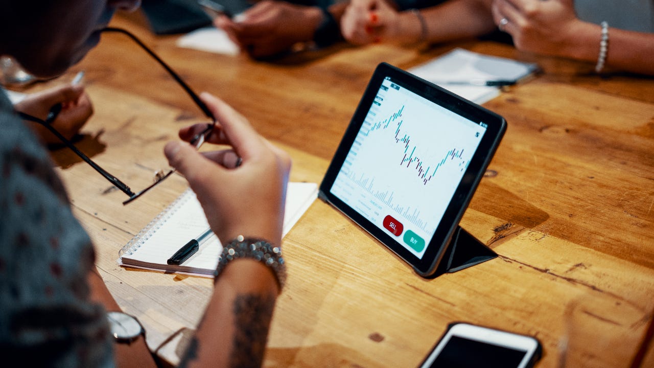 A man looks over his tablet computer while trading