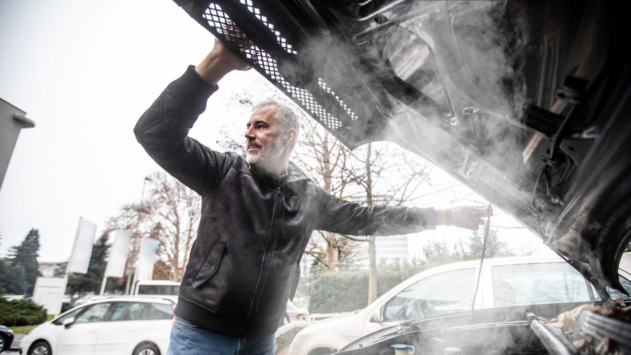 Steam Coming Out of Car Engine While Mature Man is Opening the Hood