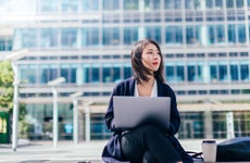 Confident Businesswoman Working With Laptop In The Financial District