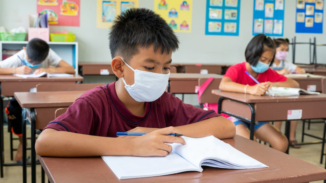 Elementary school wear mask for protect corona virus are studying.