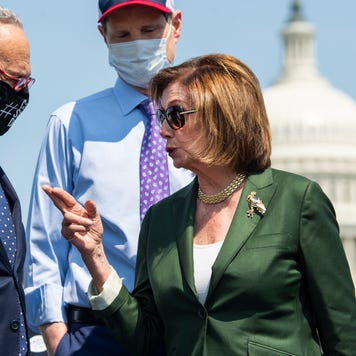 Speaker of the House Nancy Pelosi speaks with Chuck Schumer in front of the U.S. Capitol