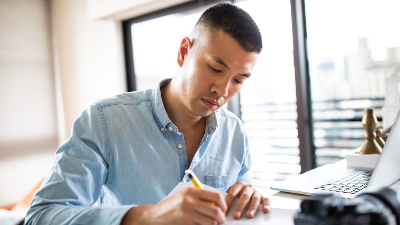 Good-looking Chinese man Signing paper documents