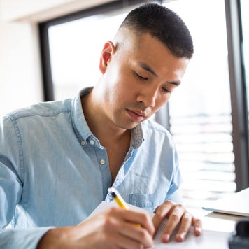 Good-looking Chinese man Signing paper documents