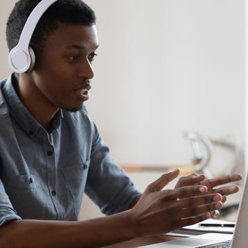 Man conducts an online lesson on his laptop