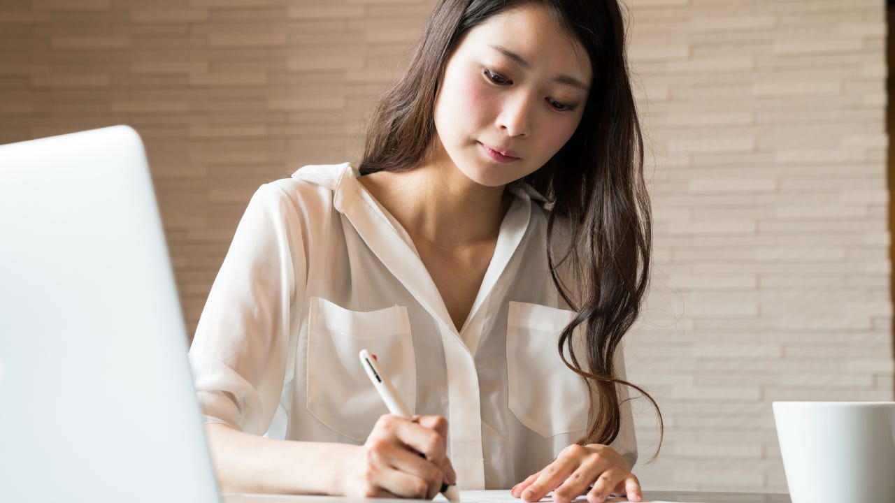 Woman filling out important paper documents