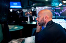 Trader looks at screen at NYSE