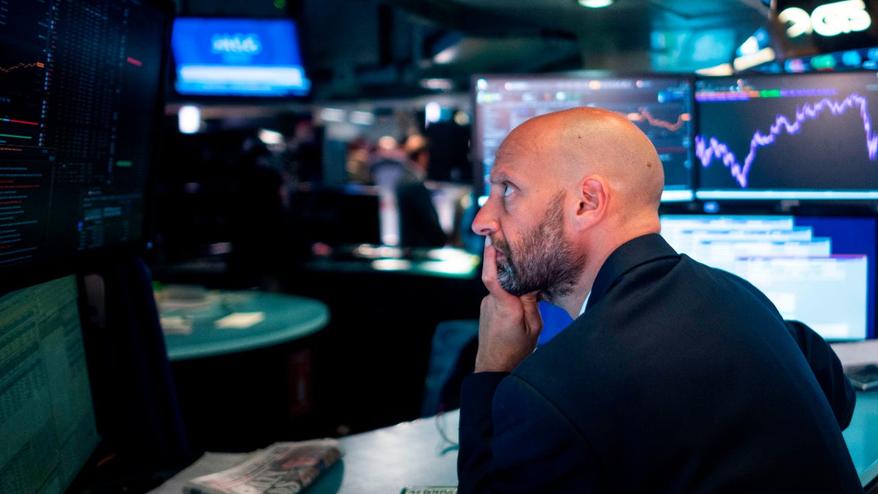 Trader looks at screen at NYSE