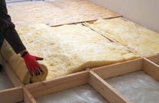 A contractor installs insulation