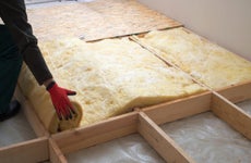 A contractor installs insulation