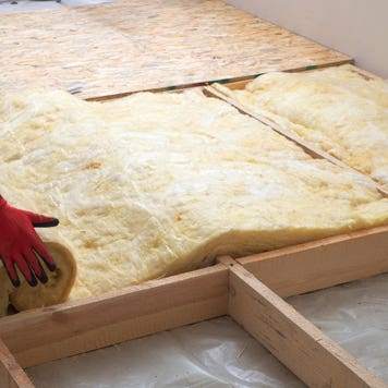 A contractor installs insulation