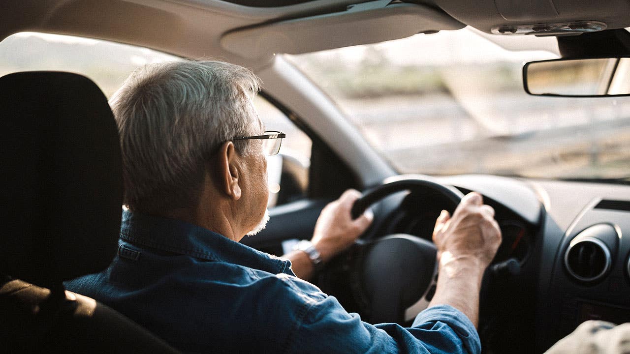 Senior man driving car on the highway