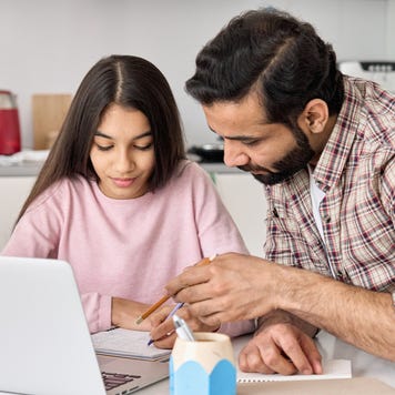 Father and daughter work on the computer together