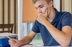 High school student concentrates on paperwork
