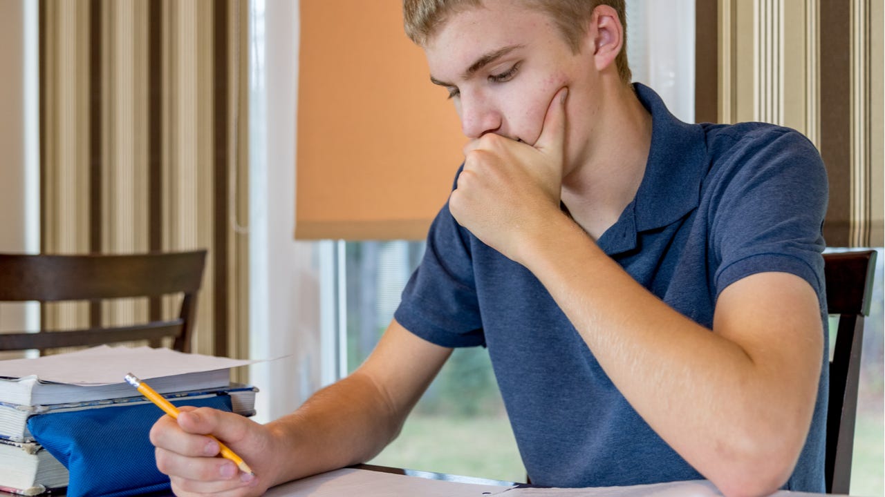 High school student concentrates on paperwork