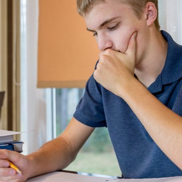 High school student concentrates on paperwork