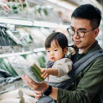 father picking out groceries with daughter
