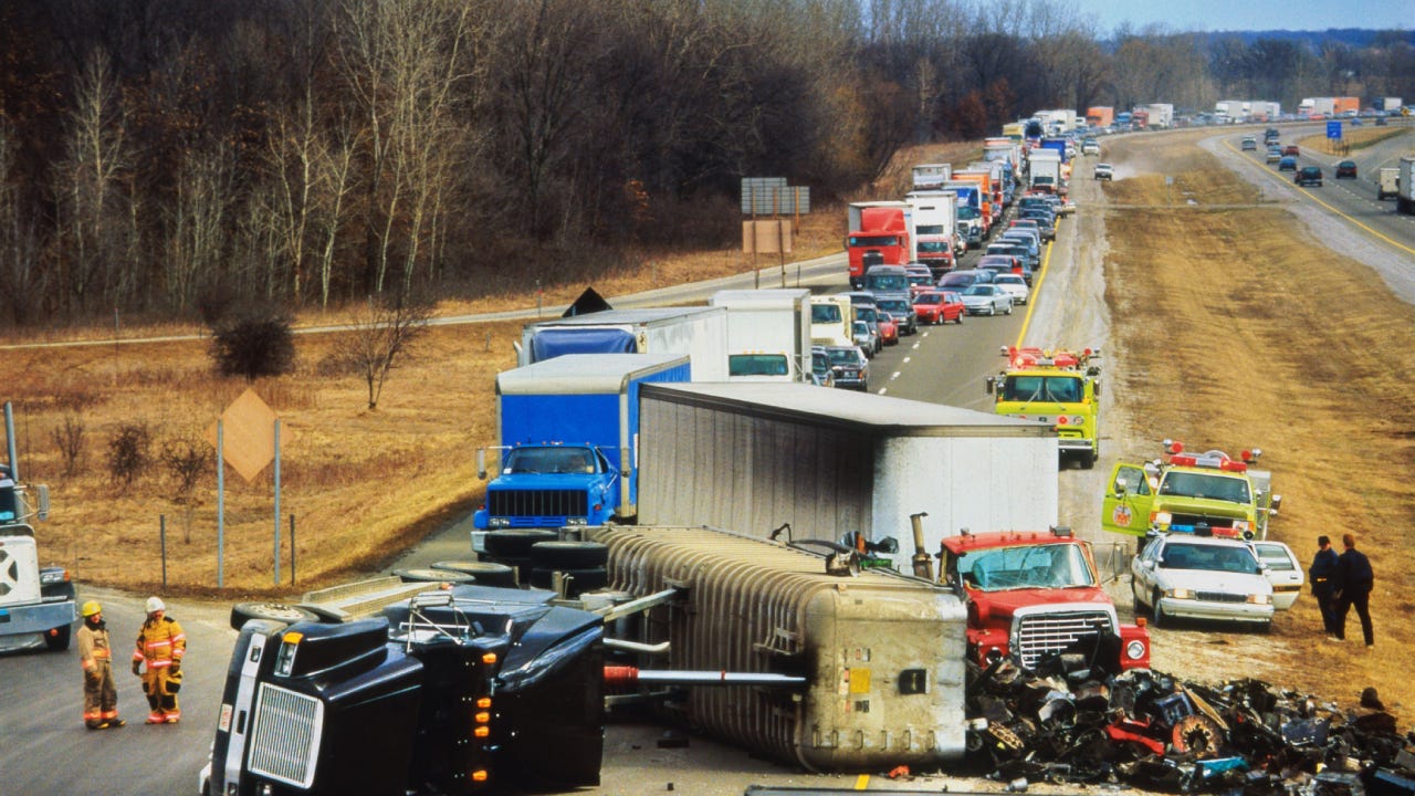 Truck overturned on highway, traffic jam behind