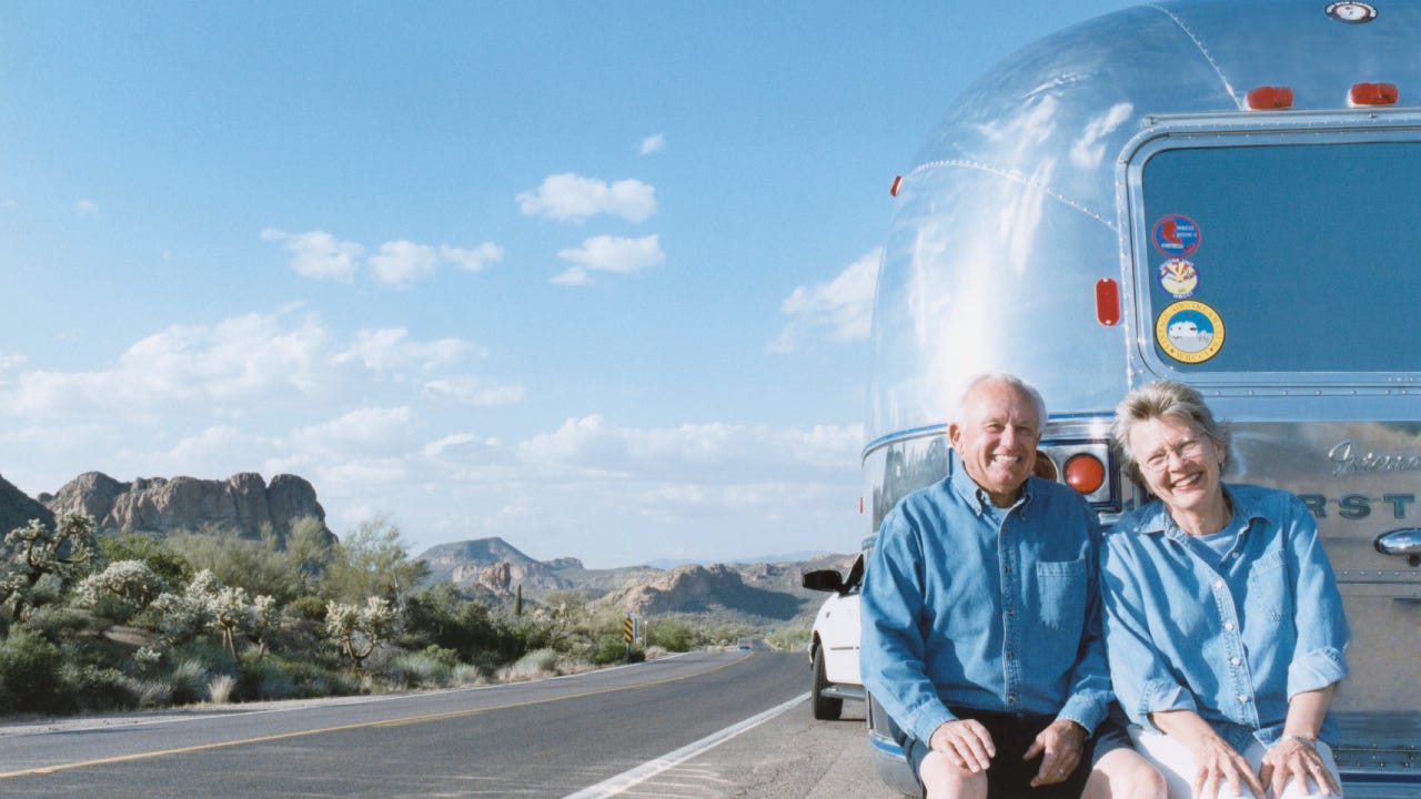 older couple outside trailer home