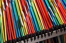 An abstract closeup of multicolored file folders in a filing cabinet