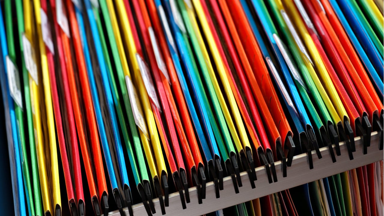 An abstract closeup of multicolored file folders in a filing cabinet