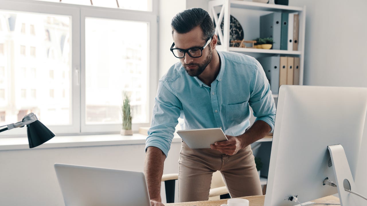 A man works from his computer at home