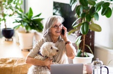 Woman on cell phone with dog