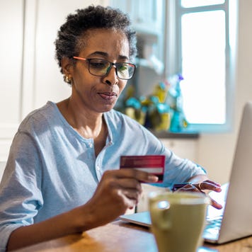 Close up of a senior woman online shopping on her laptop