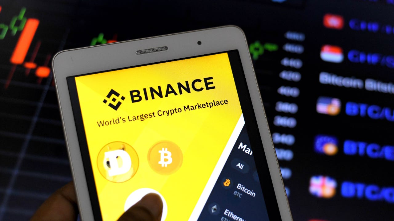 A Binance app appears on a mobile device