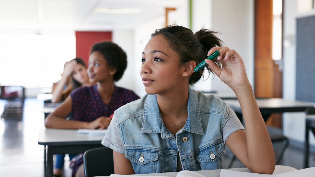 Students sit at their desks in a classroom