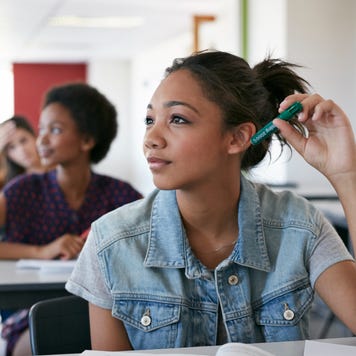 Students sit at their desks in a classroom