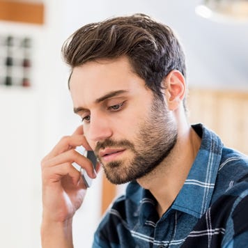 Concerned man talks on the phone