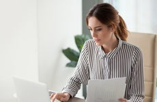 Woman pays bills at a desk