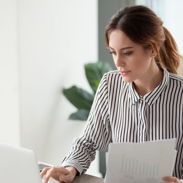 Woman pays bills at a desk