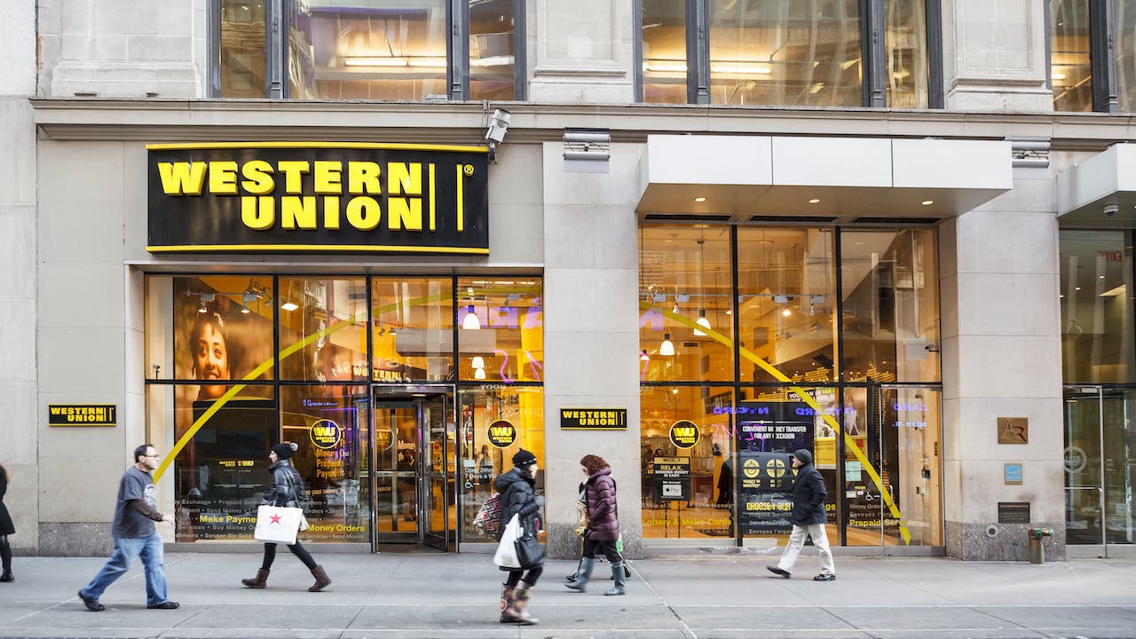 People walk by a Western Union location in New York.