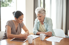 Woman assists senior with finances