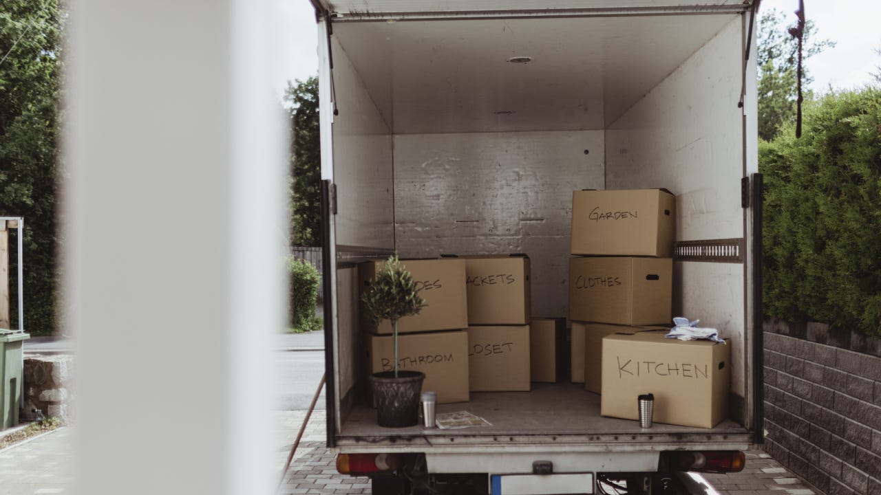 Cardboard boxes arranged in back of moving truck