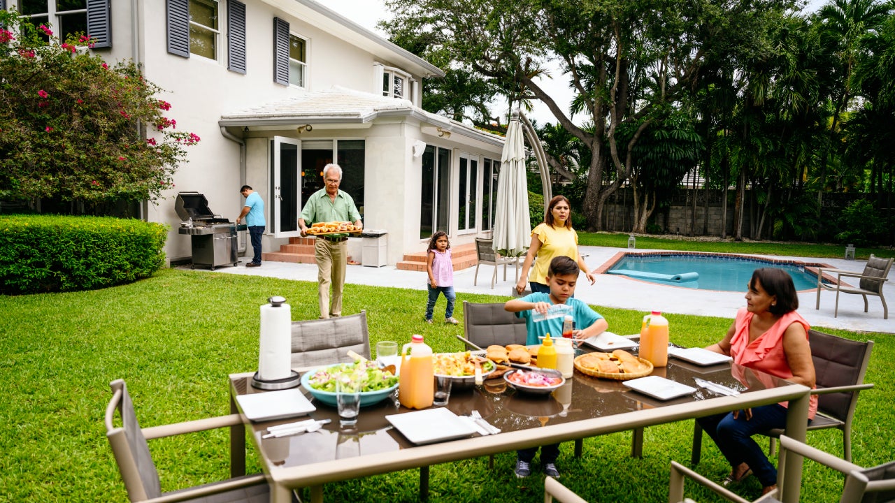 Latin American family gathering at table for outdoor meal