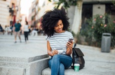 Young woman on phone with credit card