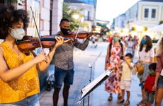 Musicians playing violins outside